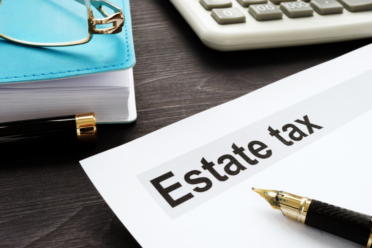 Estate tax form on a desk with a blue notebook