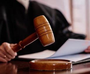 judge using gavel and holding papers