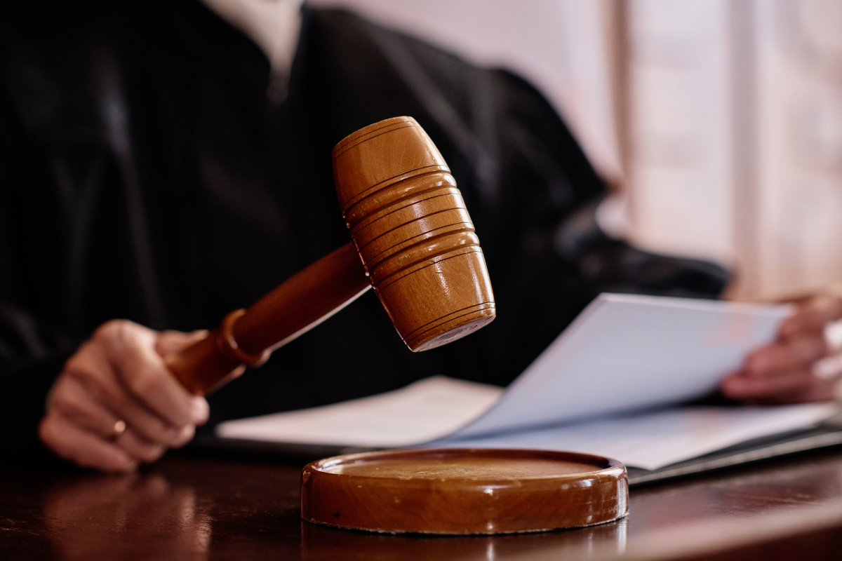 judge using gavel and holding papers