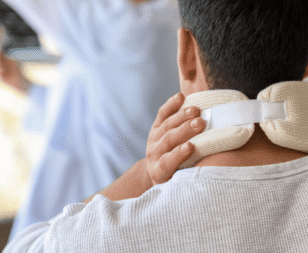 man clutching at his neck brace